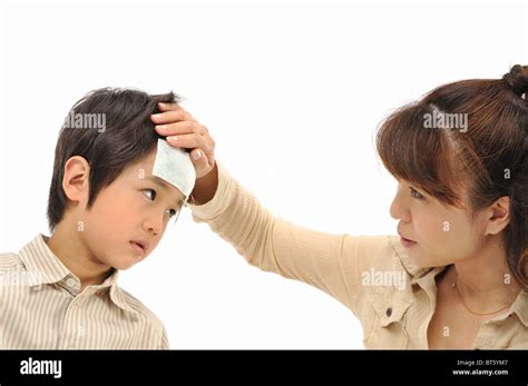 Mother Touching Son S Forehead Stock Photo Alamy