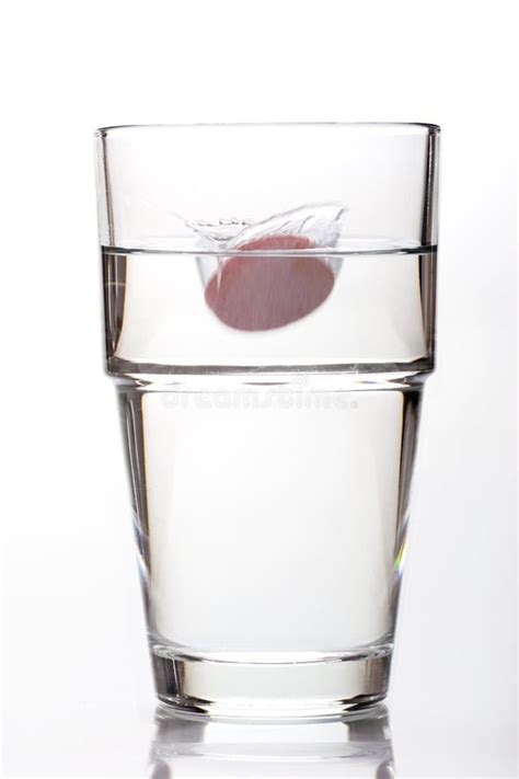 A Effervescent Tablet Falling Into A Water Glass Stock Photo Image Of