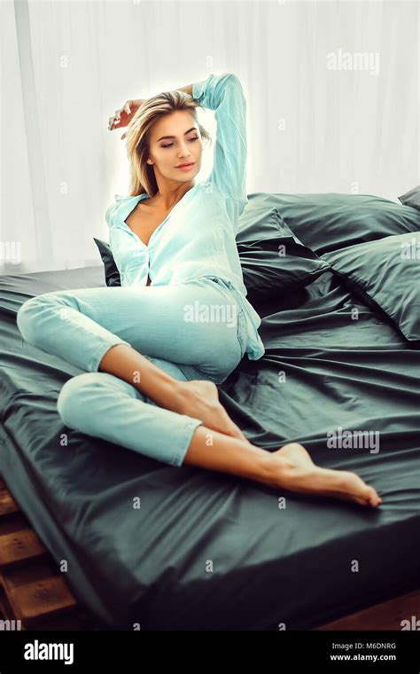 Natural Pretty Blonde Sitting On Bed Stock Photo Alamy