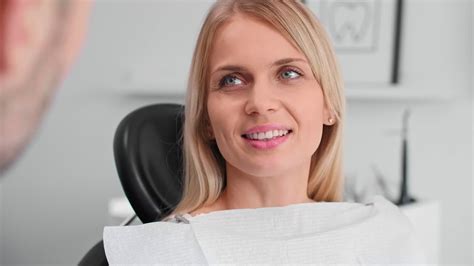 Premium stock video - Portrait of smiling woman at the dentist's office