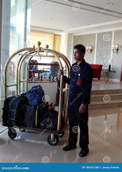 A Bellboy Holding a Trolley Full of Guest Luggage Editorial Stock Photo ...