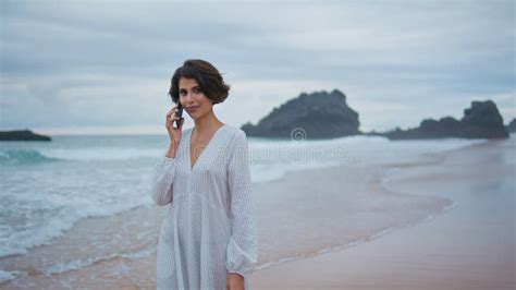 Outdoors Girl Talking Mobile At Rocky Beach Closeup Smiling Lady Looking Camera Stock Image