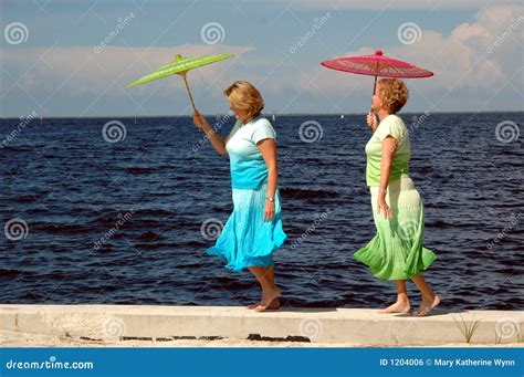 Two Mature Women Attending Art Class In Community Centre With Teacher Royalty Free Stock Image