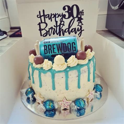 A Birthday Cake Is Decorated With Blue And White Frosting Chocolate