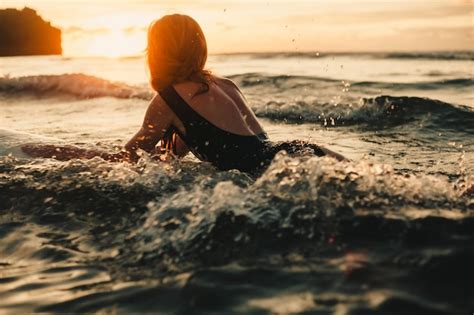 Free Photo Young Beautiful Girl Posing On The Beach With A Surfboard