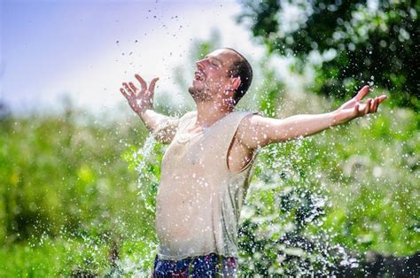 Premium Photo Portrait Of A Man Enjoying Warm Summer Rain