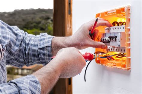 Electrician Technician Repairs The Electrical Panel Of A Residential