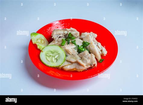 Ayam Hainan or Hainan Chicken on a red plate. Malaysian traditional ...