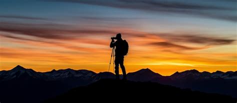 Premium Ai Image Silhouette Of A Photographer Capturing Mountain Majesty