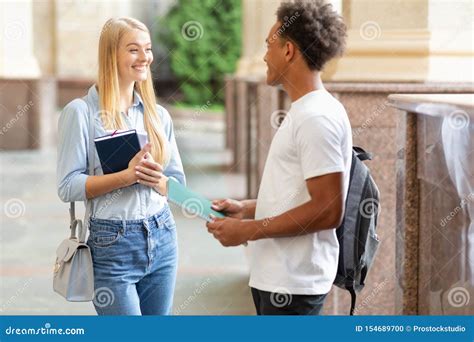 Chatting With Classmate Students Talking To Each Other Stock Photo