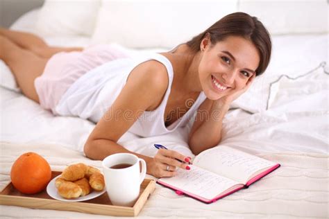 Young Beautiful Woman Lying In Bed Writing A Diary Stock Image Image