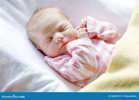 Portrait Of Cute Adorable Newborn Baby Girl Sleeping Stock Photo