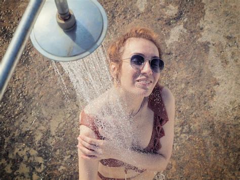 The Girl In Sunglasses And A Bikini Washes Under The Shower Outdoors Beach Shower Stock Photo