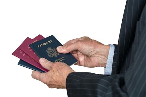 Premium Photo Cropped Hand Holding Passports Against White Background