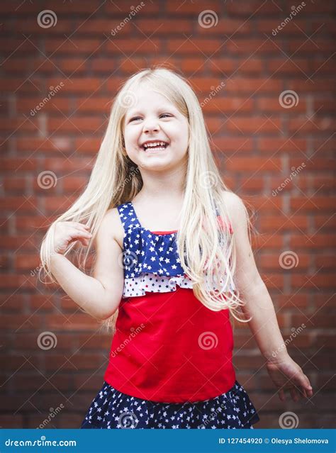 Portrait Of Laughing Girl In Wearing Stars And Stripes Dress Stock