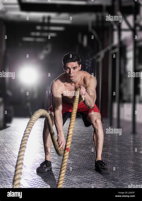 Muscular Athlete With Battle Rope Battle Ropes Exercise In The F Stock