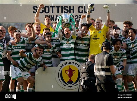 Celtics Callum McGregor Lifts The Trophy And Celebrates With His Team