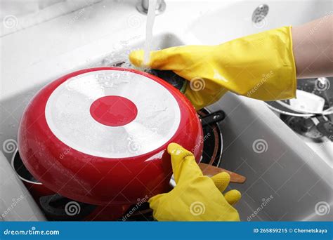 Woman Washing Frying Pan In Kitchen Sink Above View Stock Image