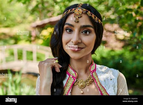 Portrait Of Brunette Indian Woman In Traditional Attire Looking At Camera During Summer Park