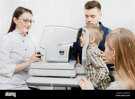 Cheerful Smiling Child Boy In Glasses Checks Eye Vision Pediatric