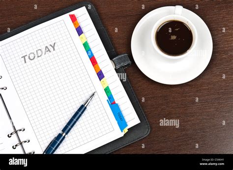 Closeup to agenda and coffee Stock Photo - Alamy