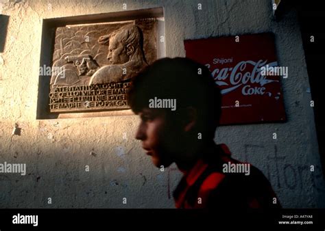 boy walking past socialist and capitalist symbols in Tirana Albania Stock Photo - Alamy