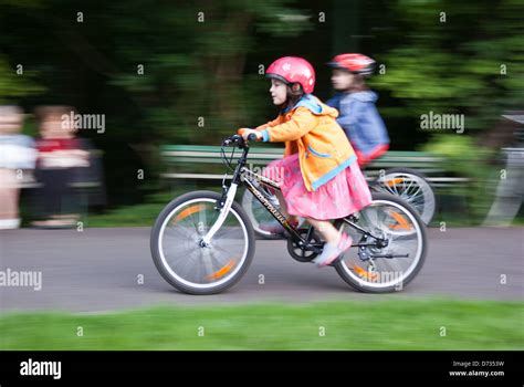 Kids riding Bikes in a park Stock Photo - Alamy