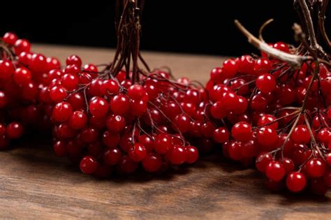 Premium Photo A Bunch Of Ripe Viburnum Berries On A Wood Background