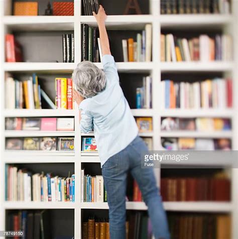 328 Woman Reaching For Book In Library Stock Photos High Res Pictures