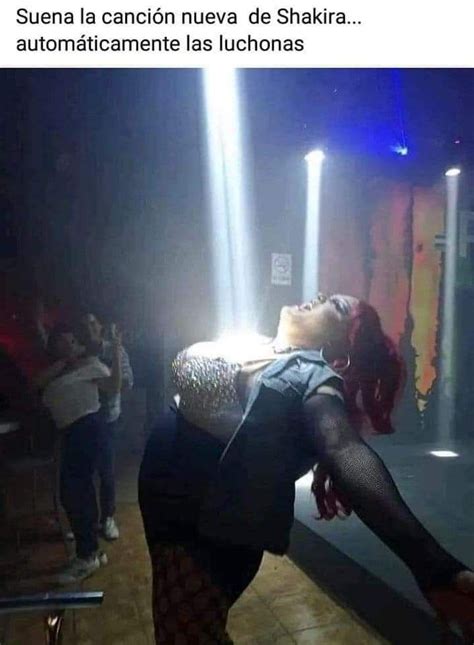 A Woman Is Dancing In The Dark With Her Legs Spread Out And Lights