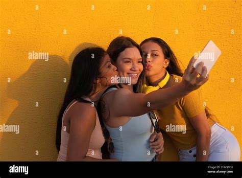 Three Latina Women In The Park Posing And Taking Selfies Femininity Concept Stock Photo Alamy