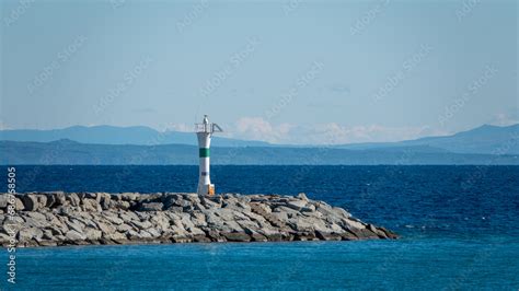 Seascape With A Lighthouse On The Kuzu Limani Harbour On The Island Of