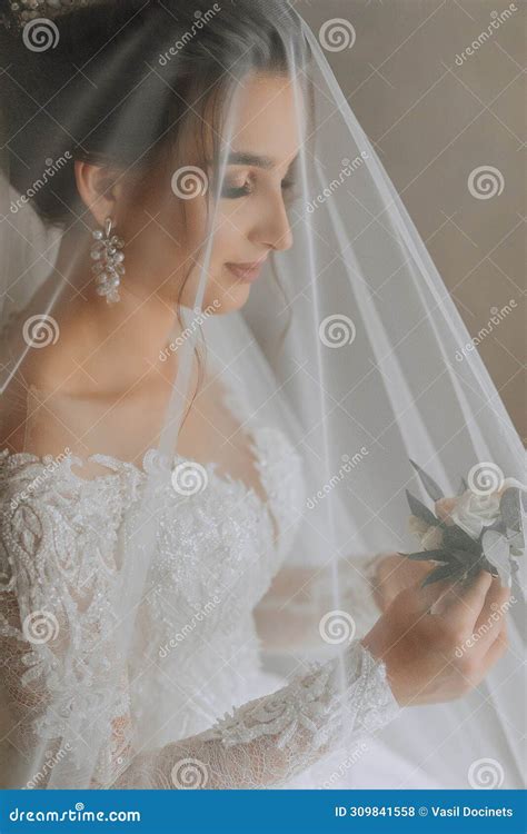 A Brunette Bride In A White Dress Holds Her Wedding Bouquet Poses Stock Photo Image Of Ivory