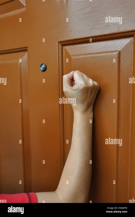 Hand Knocking On The Door Stock Photo Alamy