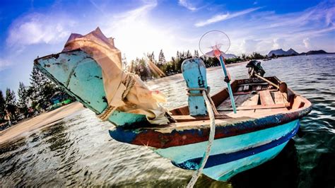 Premium Photo Fishing Boats Moored In Sea Against Sky