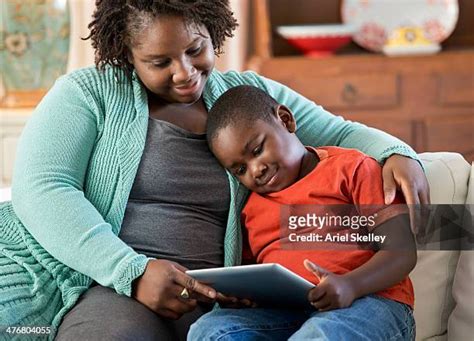 Black Mother And Son Using Digital Tablet Together High Res Stock Photo