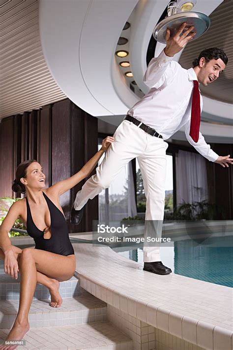 Woman Pushing Waiter Into Swimming Pool Stock Photo - Download Image ...