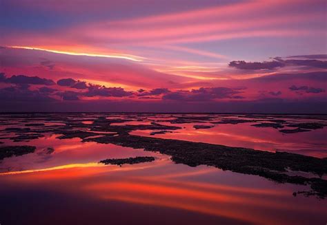 Premium Photo | Beautiful orange sunset on the shore of the beach