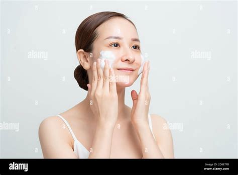 Face Skin Care Woman Applying Facial Cleanser On Face Closeup Girl