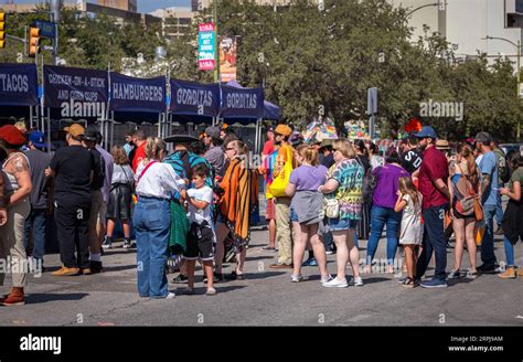 Large crowd of people are waiting in line to buy street food Stock Photo - Alamy