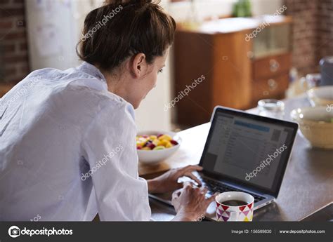 Young woman using laptop Stock Photo by ©monkeybusiness 156589830