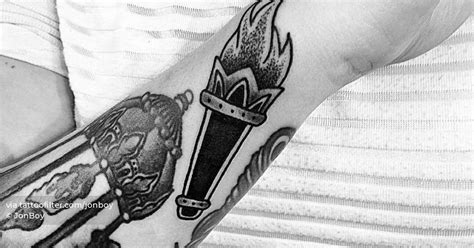 Torch tattoo located on the wrist.