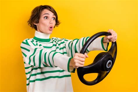 Photo of Surprised Young Woman Wear Turtleneck Hold Steering Wheel Rent ...