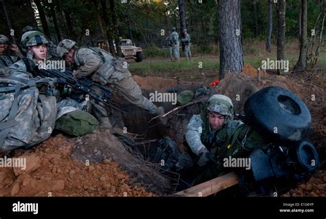 U.S. Soldiers leave their defensive fighting positions while preparing ...