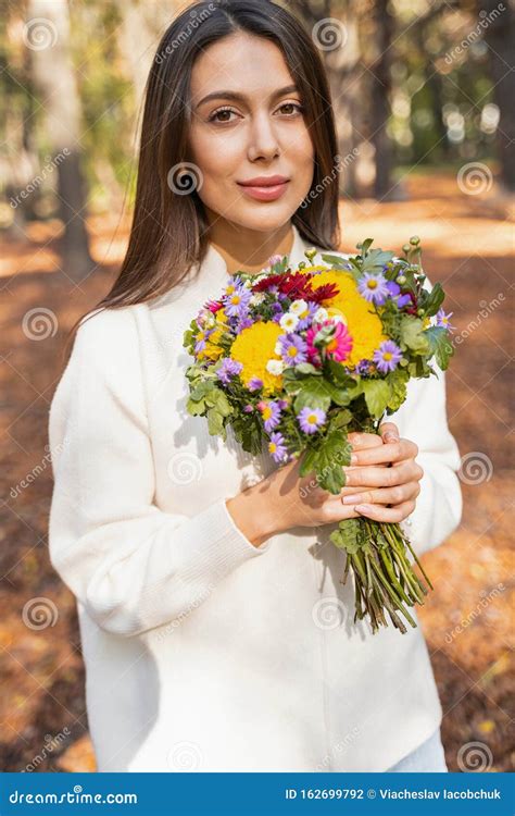 Beautiful Woman Being Grateful Receiving Pretty Flowers Stock Photo