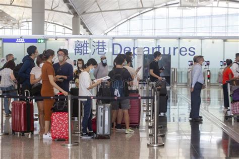 Passengers Wearing Masks Line Up At The Check In Counter In The Hong