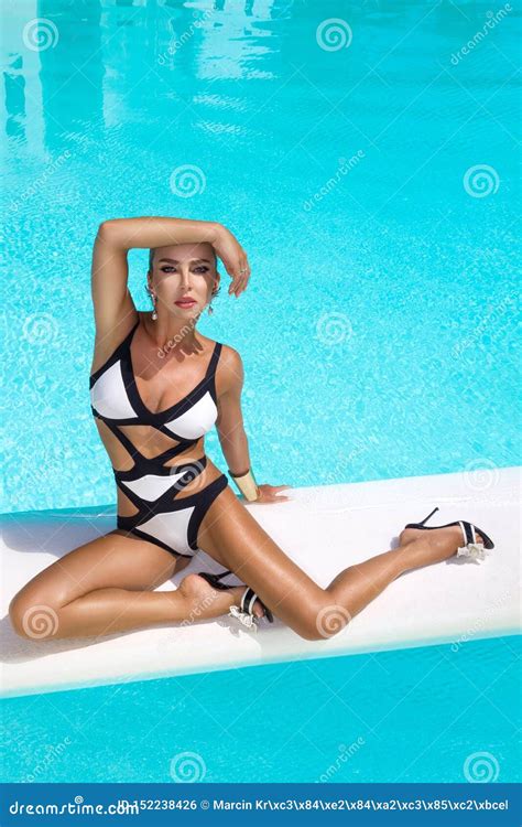 Elegant Woman In Luxury Bikini On The Sun Tanned Slim And Shapely Body