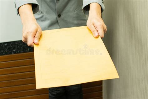 A Man Is Giving A Brown Envelope Stock Photo Image Of Mail Male