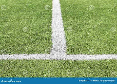 Marking White Paint On A Green Grass Of The Football Field Stock Photo