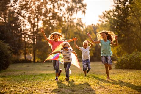Group of happy children running in public park - Review of Myopia